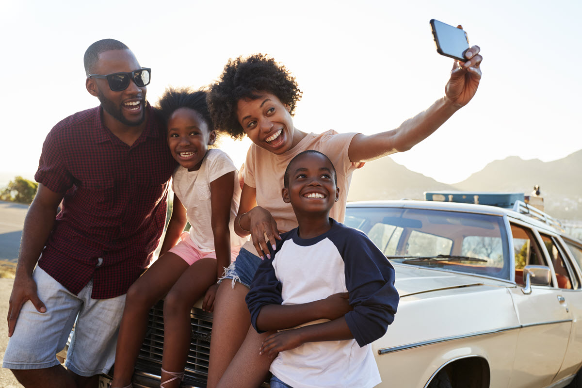 two parents and two kids taking a selfie