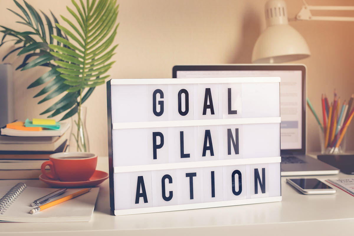 goal plan action sign on a desk